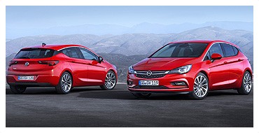 Dwa czerwone samochody marki opel